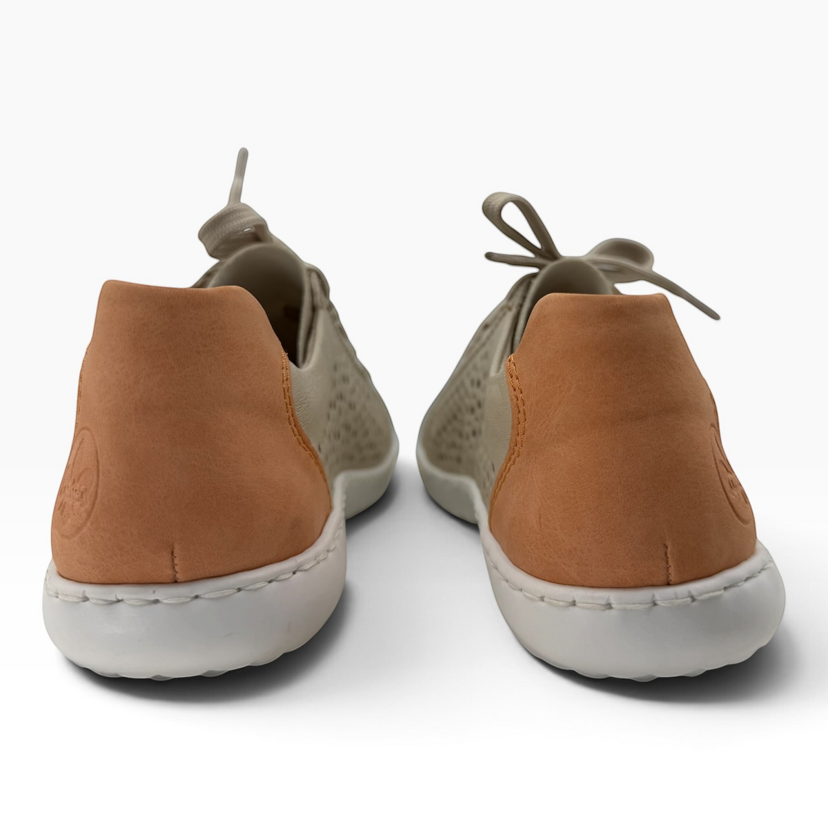 The Shoe Shop Dana leather sneakers in beige and tan with laser-cut detailing and white rubber soles, back view.