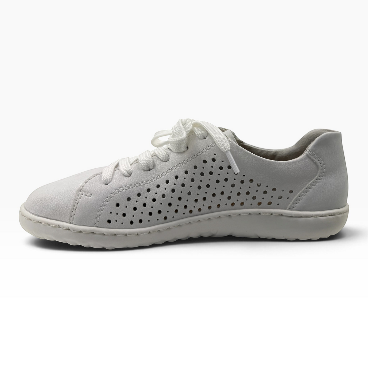 The Shoe Shop Dana white leather sneaker with laser-cut perforations, lace-up front, and flexible rubber sole.