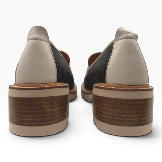 The Shoe Shop Delmira loafer featuring a two-tone textured upper, sturdy block heel, and chunky tread sole, back view.