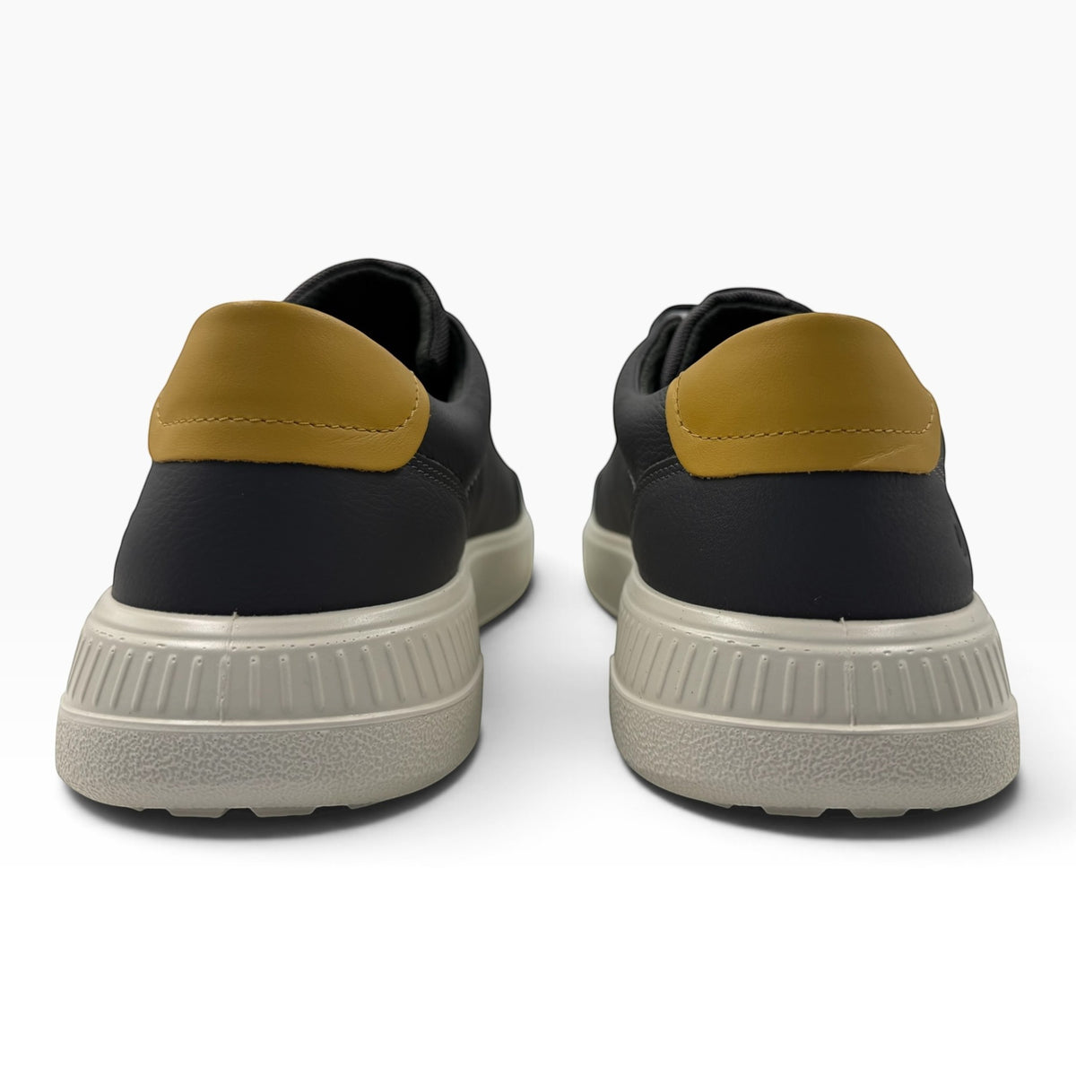 The Shoe Shop Ecco Move sneakers in black leather with mustard heel tabs and textured beige soles, rear view.