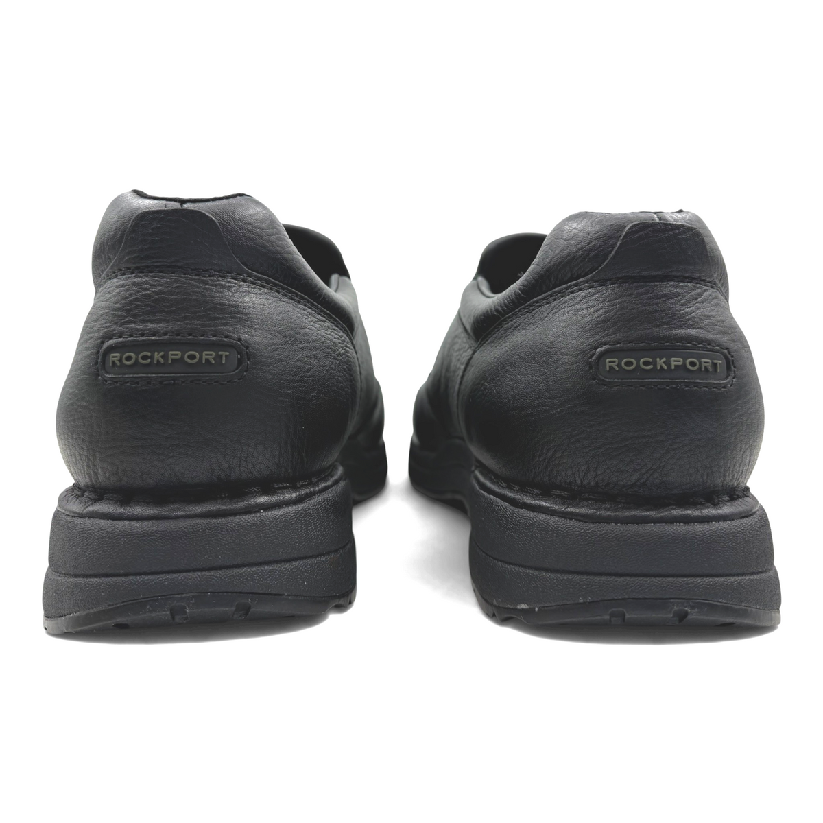 The Shoe Shop Edge Hill black leather slip-on shoes viewed from the back showing the Rockport logo on the heel