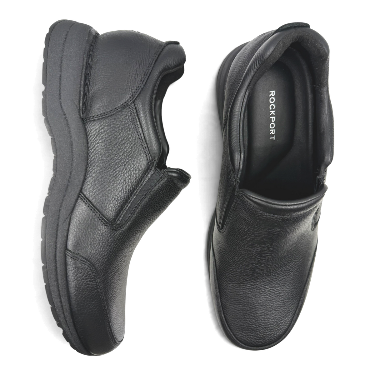 The Shoe Shop Edge Hill black leather slip-on walking shoes with cushioned soles, top-down view.
