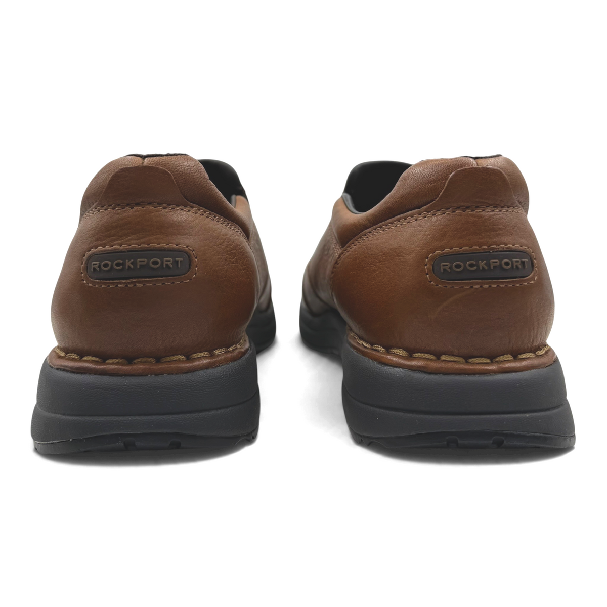 The Shoe Shop Edge Hill brown leather casual shoes, back view showing Rockport branding and black rubber soles.