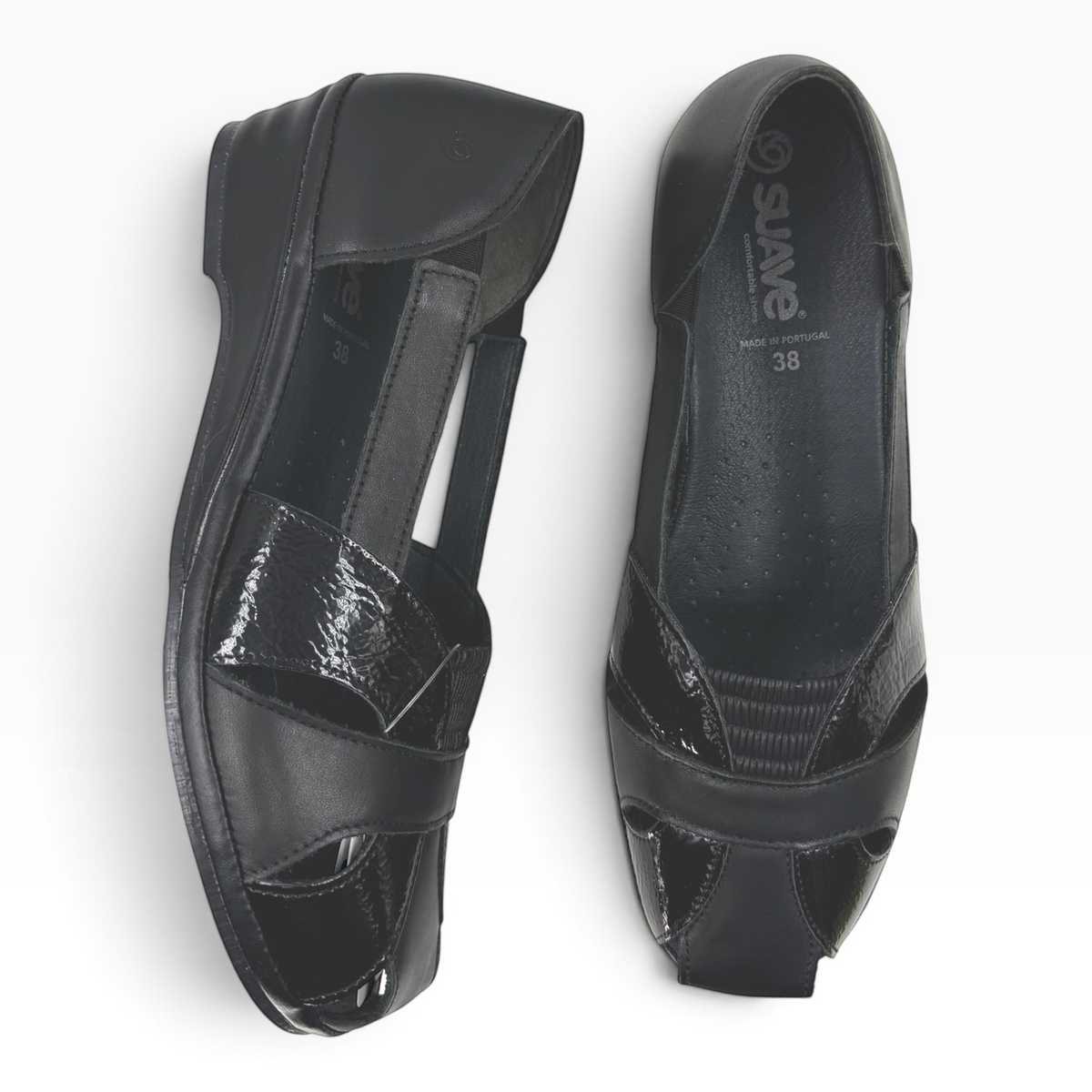 The Shoe Shop Elson black leather peep-toe flats with patent detailing, side cut-outs, and a low wedge sole.