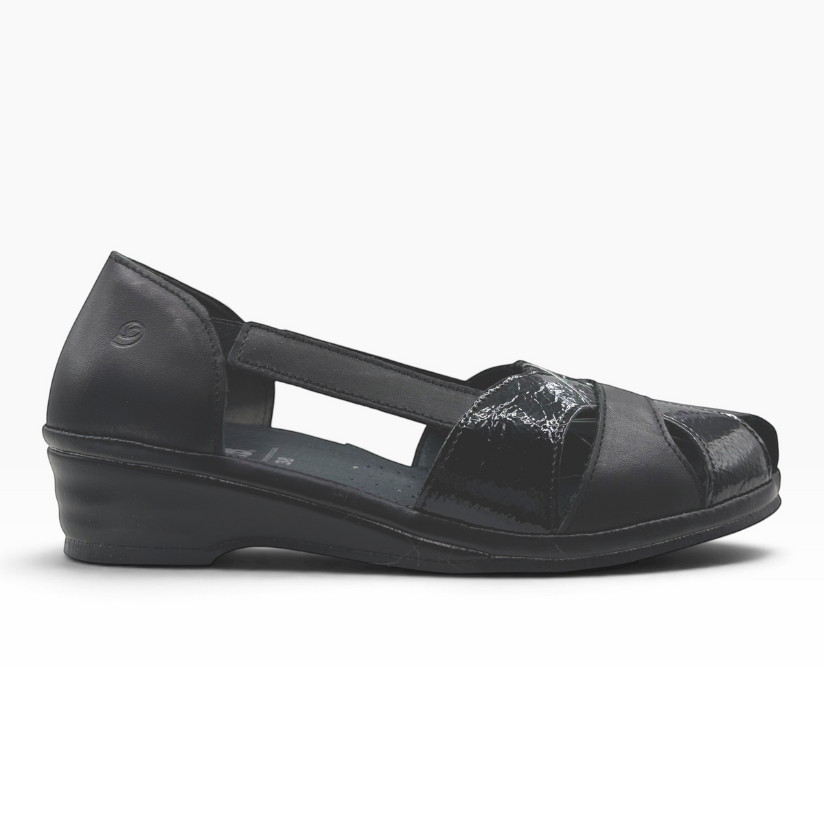 The Shoe Shop Elson flat in black leather with peep-toe, side cut-outs, and a low wedge heel.