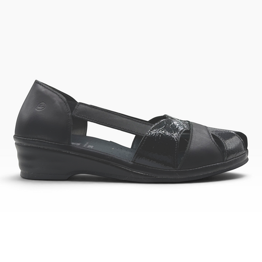 The Shoe Shop Elson flat in black leather with peep-toe, side cut-outs, and a low wedge heel.
