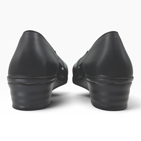 The Shoe Shop Elson flat in black leather, showing the back view of the low wedge heel and cushioned construction.