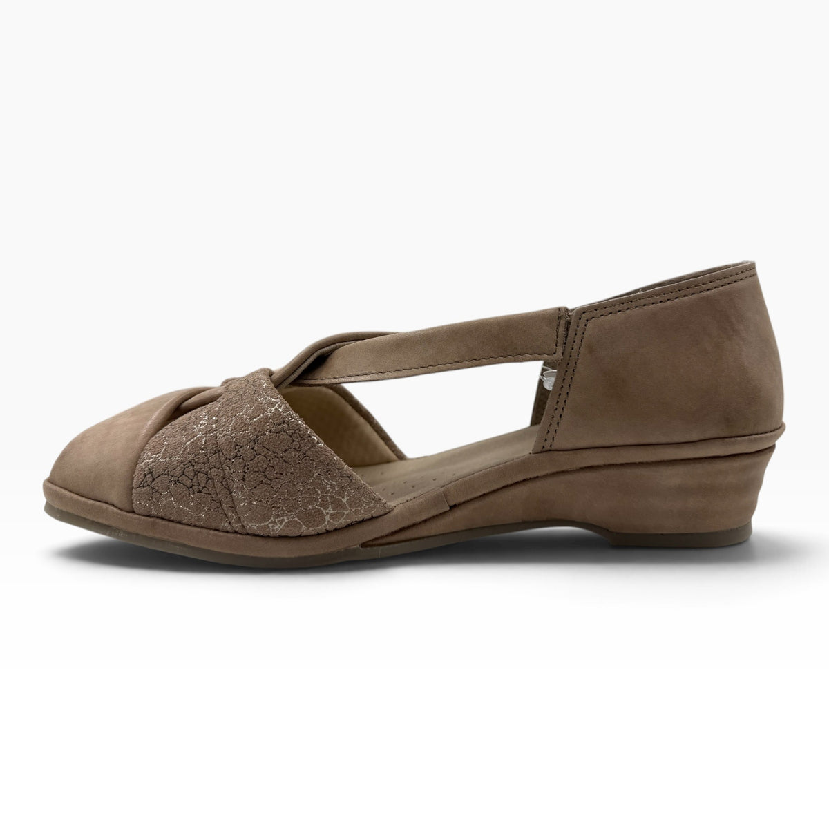 The Shoe Shop Emerald taupe suede flat sandal with crossed straps, textured detailing, and a low wedge heel.