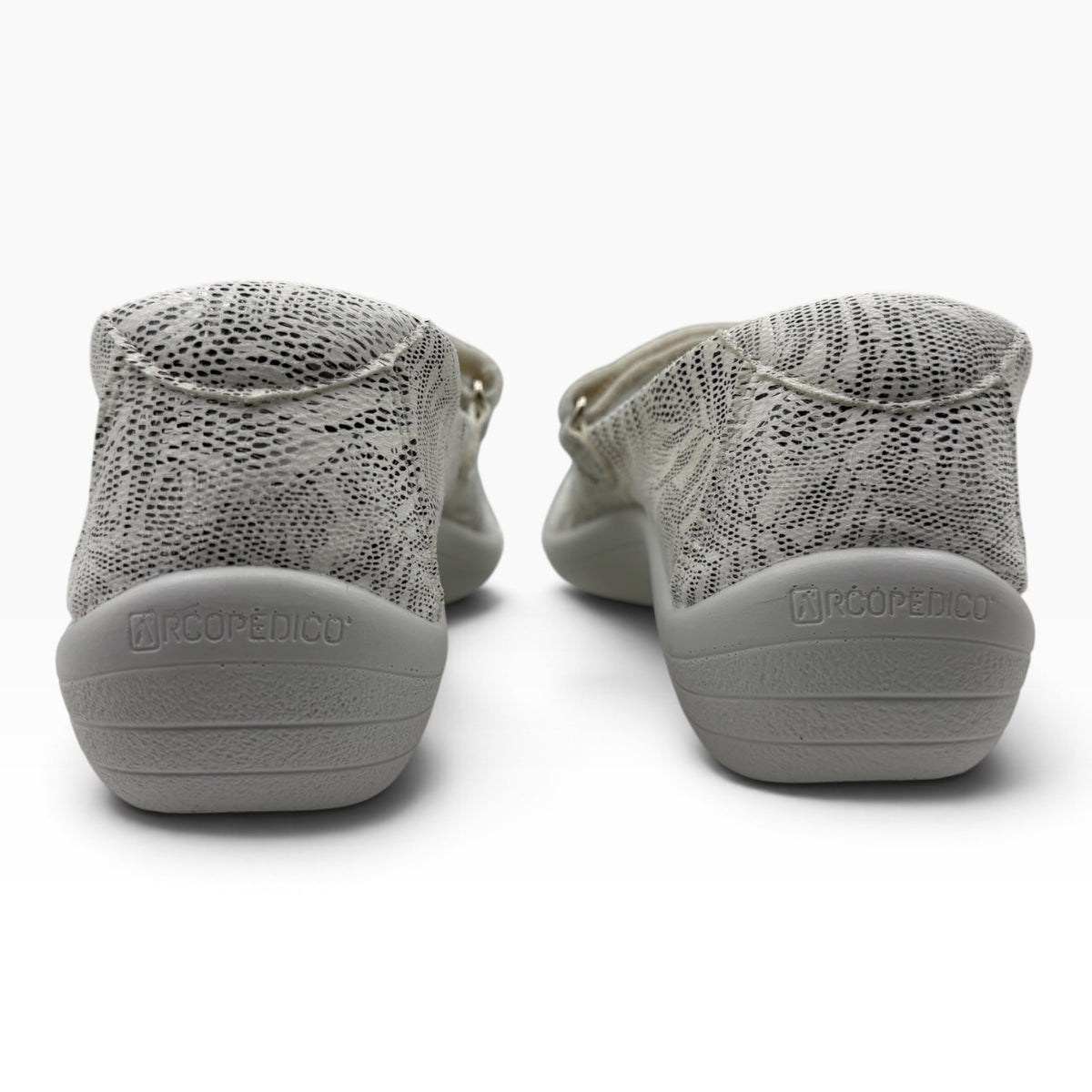 The Shoe Shop Estrela Mary-Jane flats in white with a textured palm tree pattern and supportive grey rubber soles.