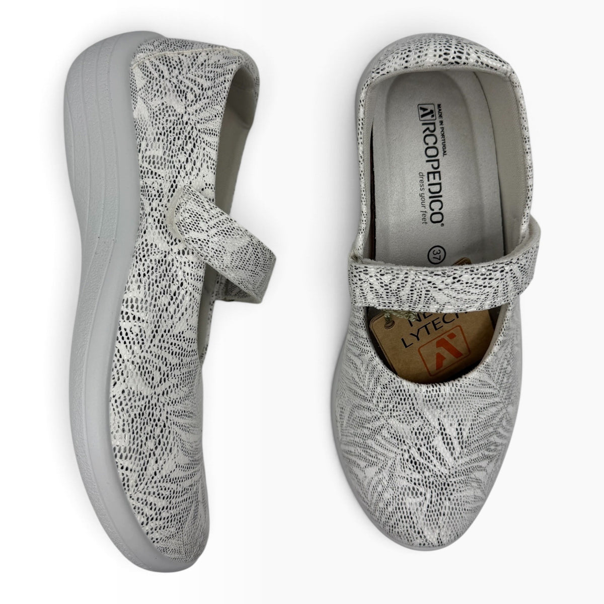 The Shoe Shop Estrela Mary-Jane flat in white with black palm tree print, featuring an adjustable strap and Lytech.
