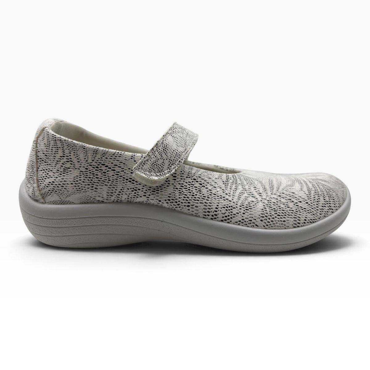 The Shoe Shop Estrela Mary-Jane flat in white with a textured palm tree pattern, adjustable strap, and grey sole.
