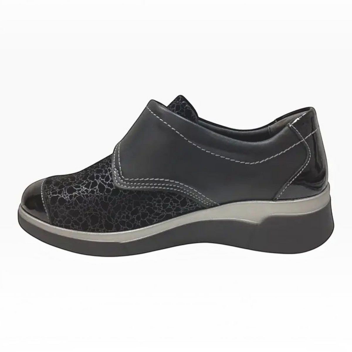 The Shoe Shop Ezra black leather shoe with patent detailing, Velcro strap, and a supportive low wedge sole.