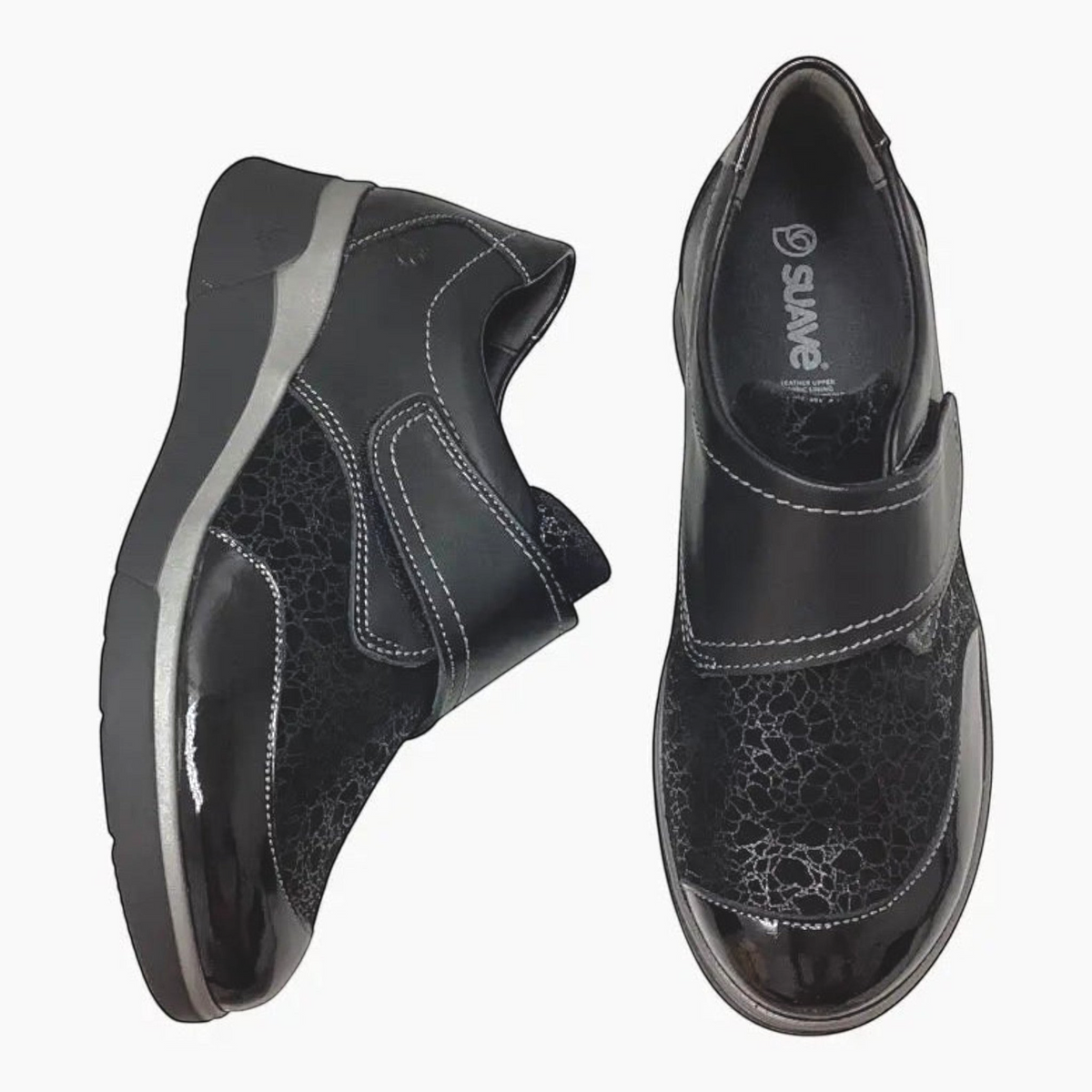The Shoe Shop Ezra black leather comfort shoes with patent detailing, Velcro strap, and supportive low wedge sole.