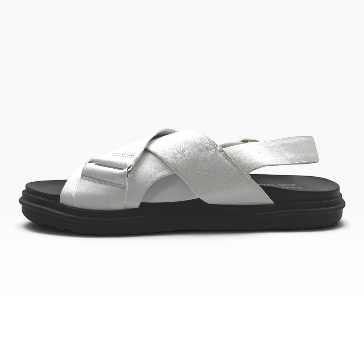 The Shoe Shop Faye sandal in white leather with crossed straps, adjustable heel buckle, and black ridged rubber sole.