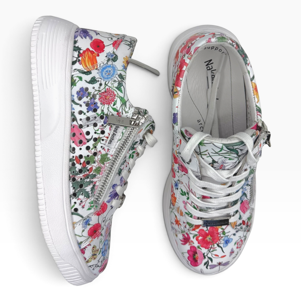 The Shoe Shop Naked Arches Noble floral leather sneakers with side zip, lace-up front, and white platform sole.