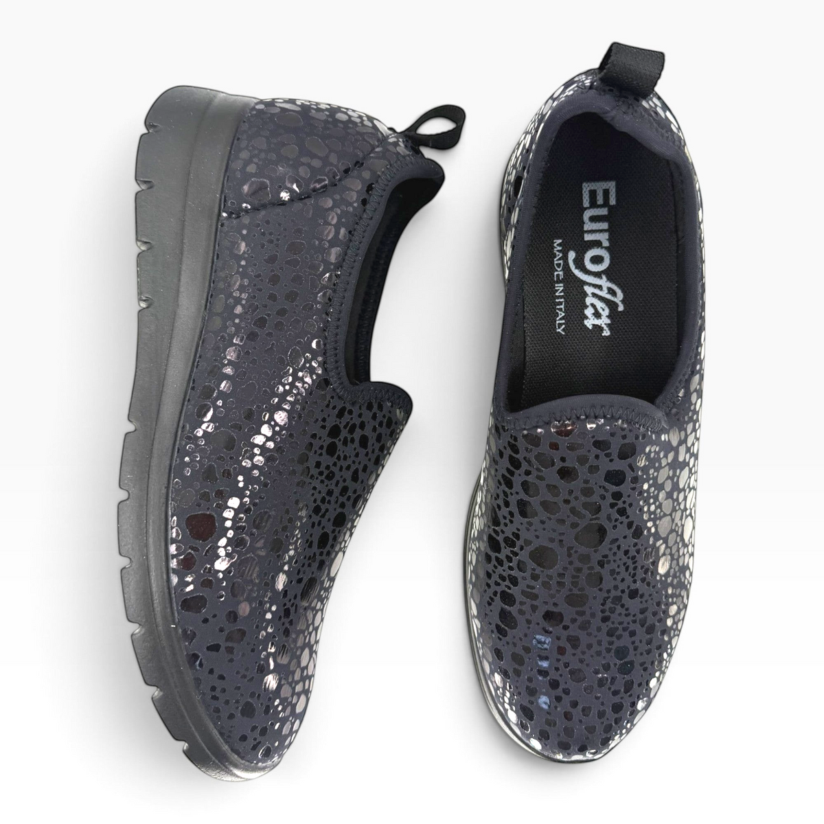 The Shoe Shop Florence slip-on shoes in black with a metallic patterned stretch upper and cushioned sole.