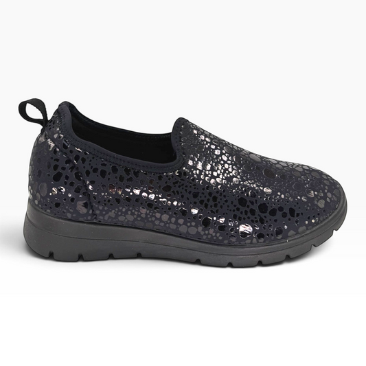 The Shoe Shop Florence slip-on shoe in black with a textured metallic spotted pattern and a flexible pull tab.