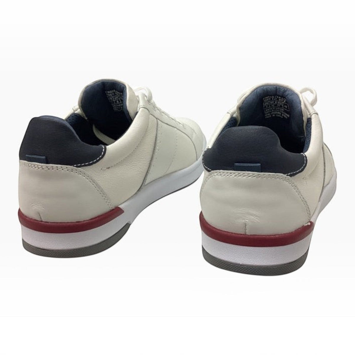 The Shoe Shop Florsheim Crossover white leather sneakers with navy heel tabs and red midsole accents, rear view.
