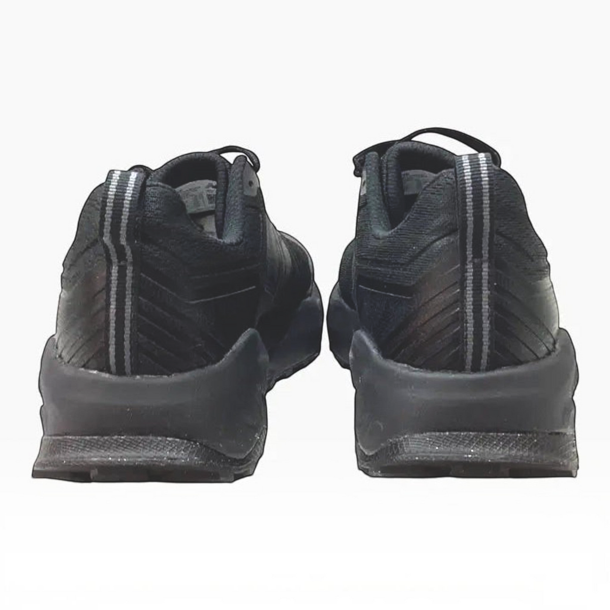 The Shoe Shop Garoé V2 all-black trail running shoes viewed from the back, showing heel pull tabs and mesh texture.