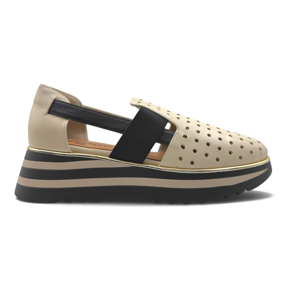 The Shoe Shop Gelato Gap beige perforated slip-on flat with black elastic strap and striped platform sole.