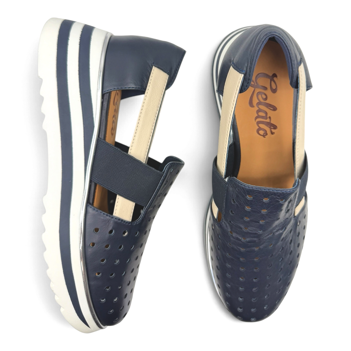 The Shoe Shop Gelato navy perforated leather slip-on flats with elastic strap and striped platform sole.
