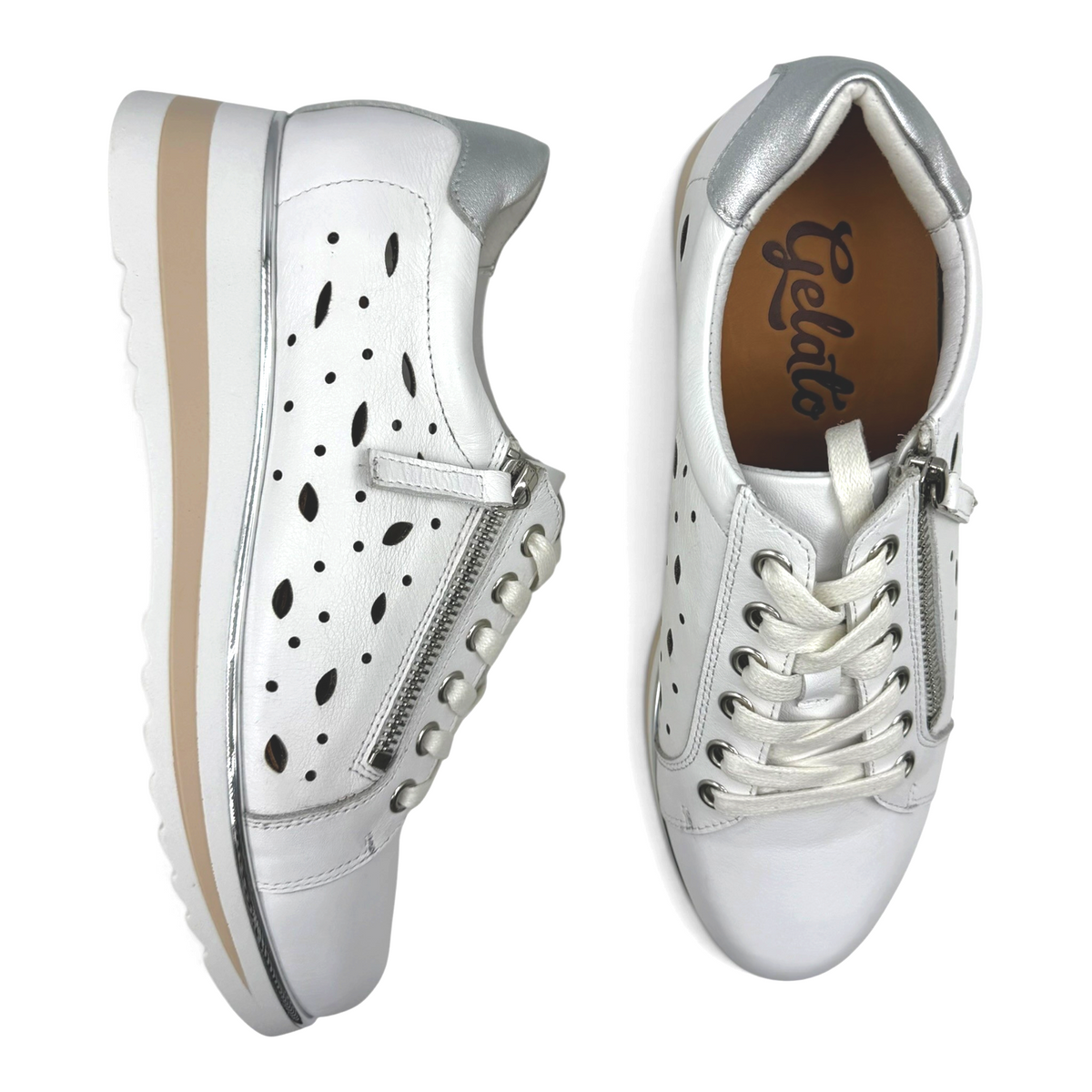 The Shoe Shop Goldie white leather sneakers with silver accents, laser-cut detailing, and side zipper closure.