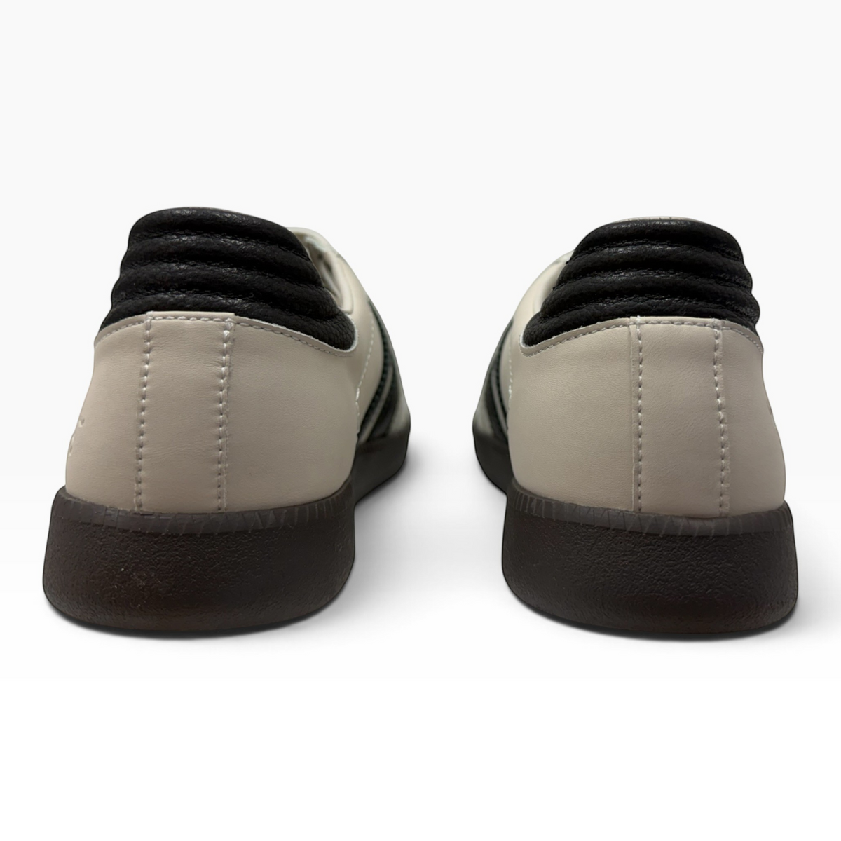 Rear view of The Shoe Shop Gordon sneakers featuring beige suede, black leather trim, and a durable gum rubber sole.
