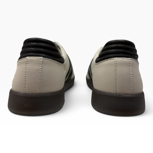 Rear view of The Shoe Shop Gordon sneakers featuring beige suede, black leather trim, and a durable gum rubber sole.
