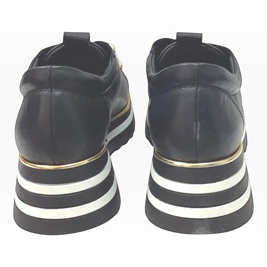 The Shoe Shop Bresley Gyro black leather platform sneakers with striped flatform sole and gold trim, rear view.