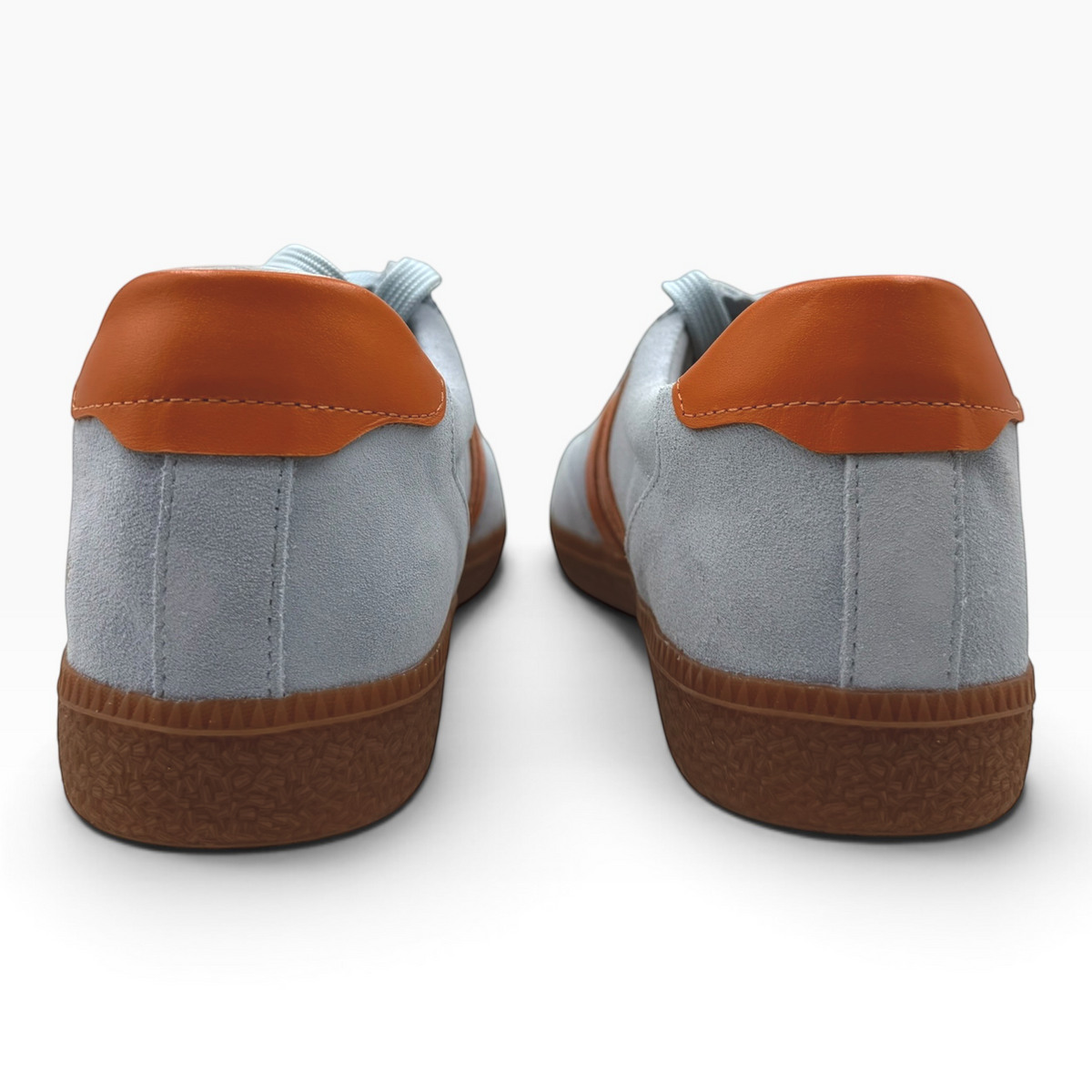 The Shoe Shop Hamptons sneakers in light grey suede with tan leather heel tabs and textured brown rubber soles.