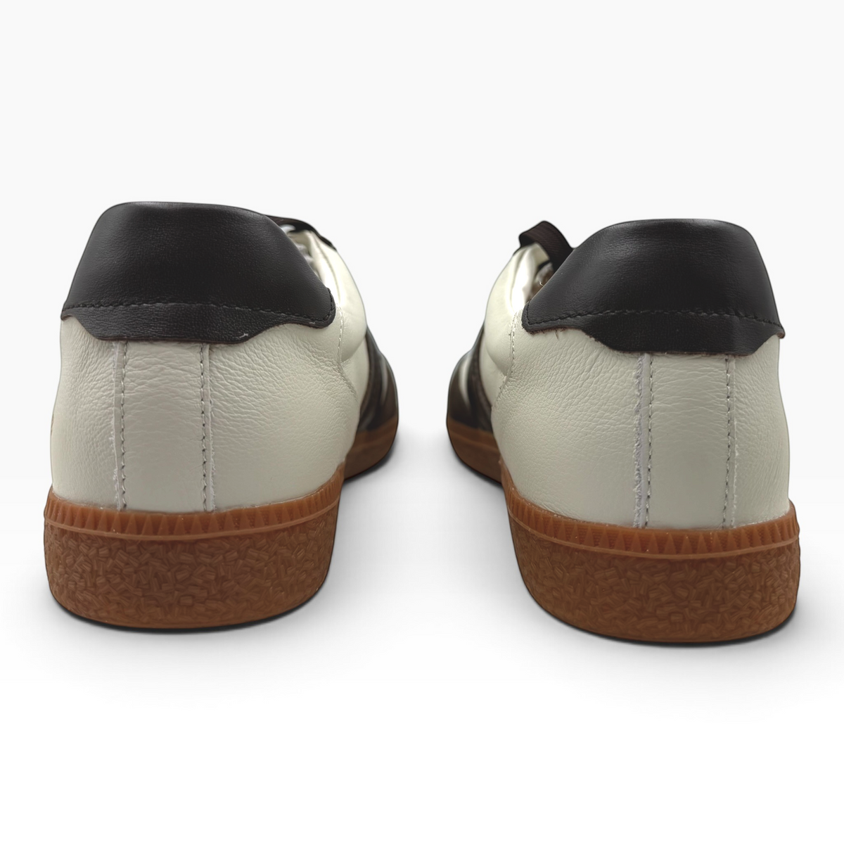 Back view of The Shoe Shop Hamptons sneakers featuring white leather, dark brown accents, and gum rubber soles.