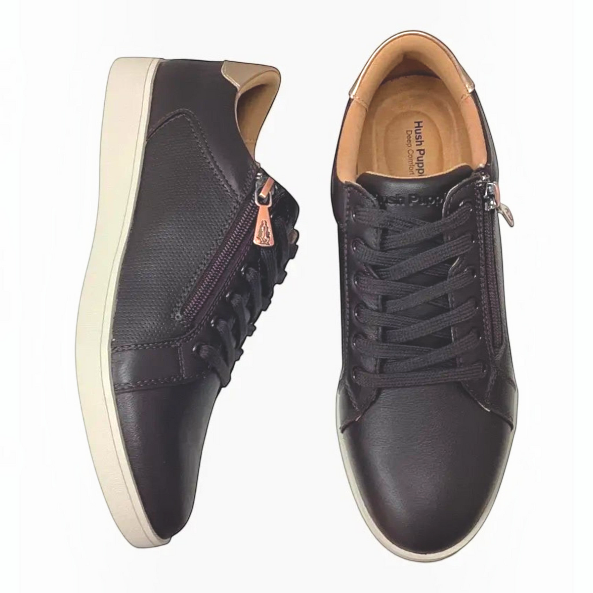 The Shoe Shop Hush Puppies Mimosa black leather sneakers with side zip, perforated panels, and gunmetal heel detail.