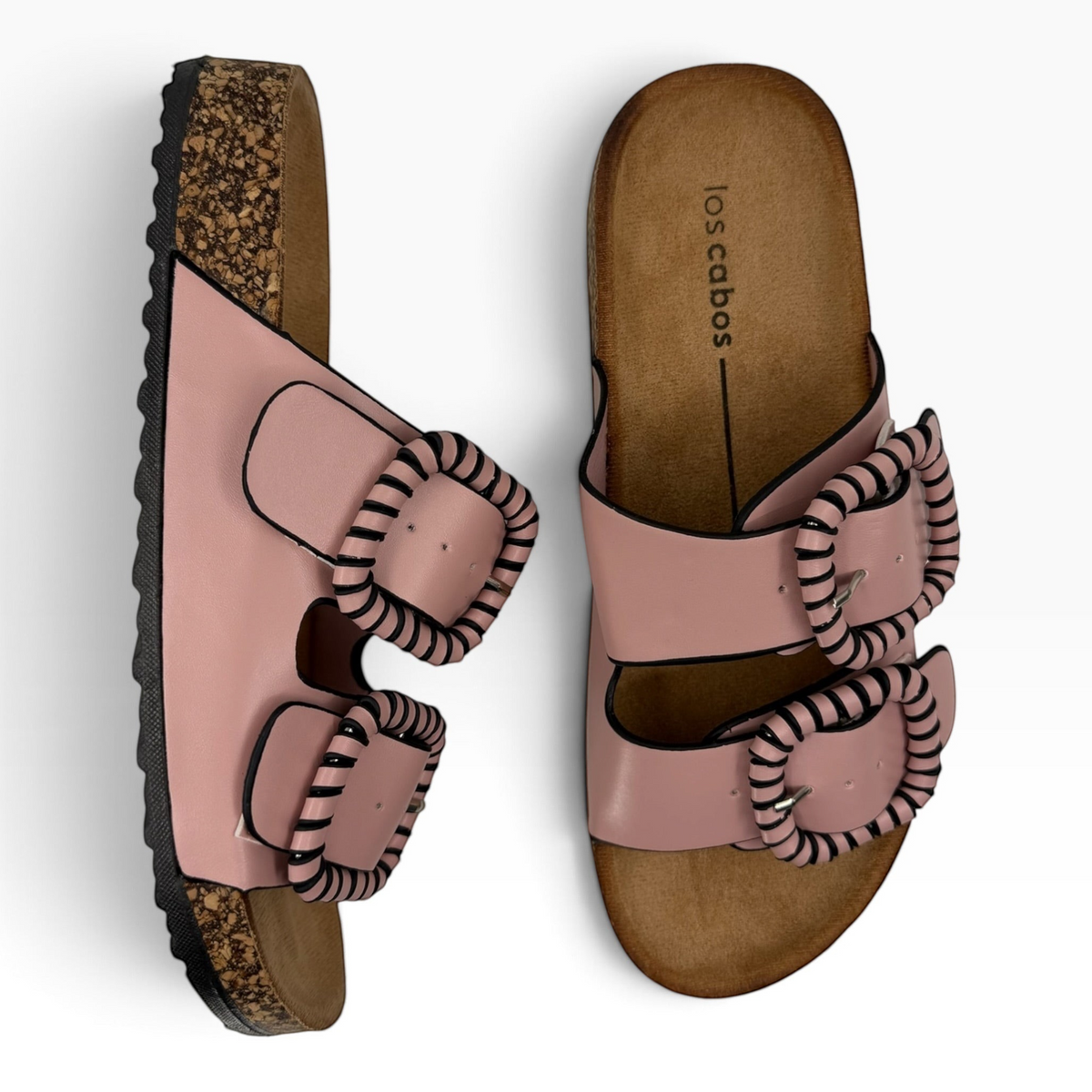 The Shoe Shop Jirona leather slides in dusty pink with two adjustable straps, statement buckles, and cork footbeds.