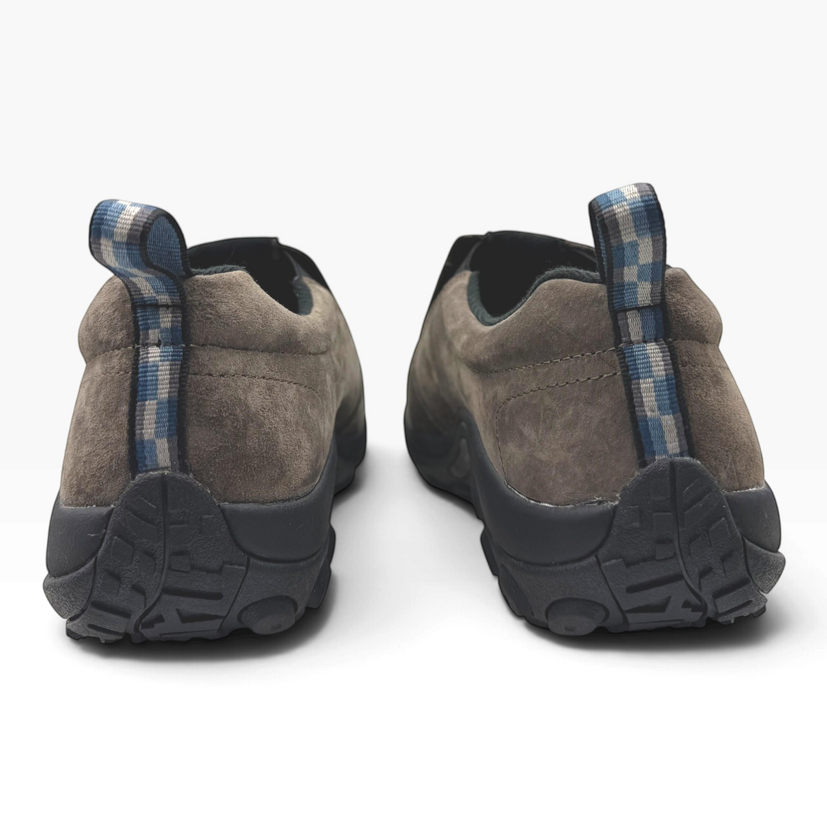 The Shoe Shop Jungle Moc in fudge brown suede with a blue checkered heel pull tab, viewed from the back.
