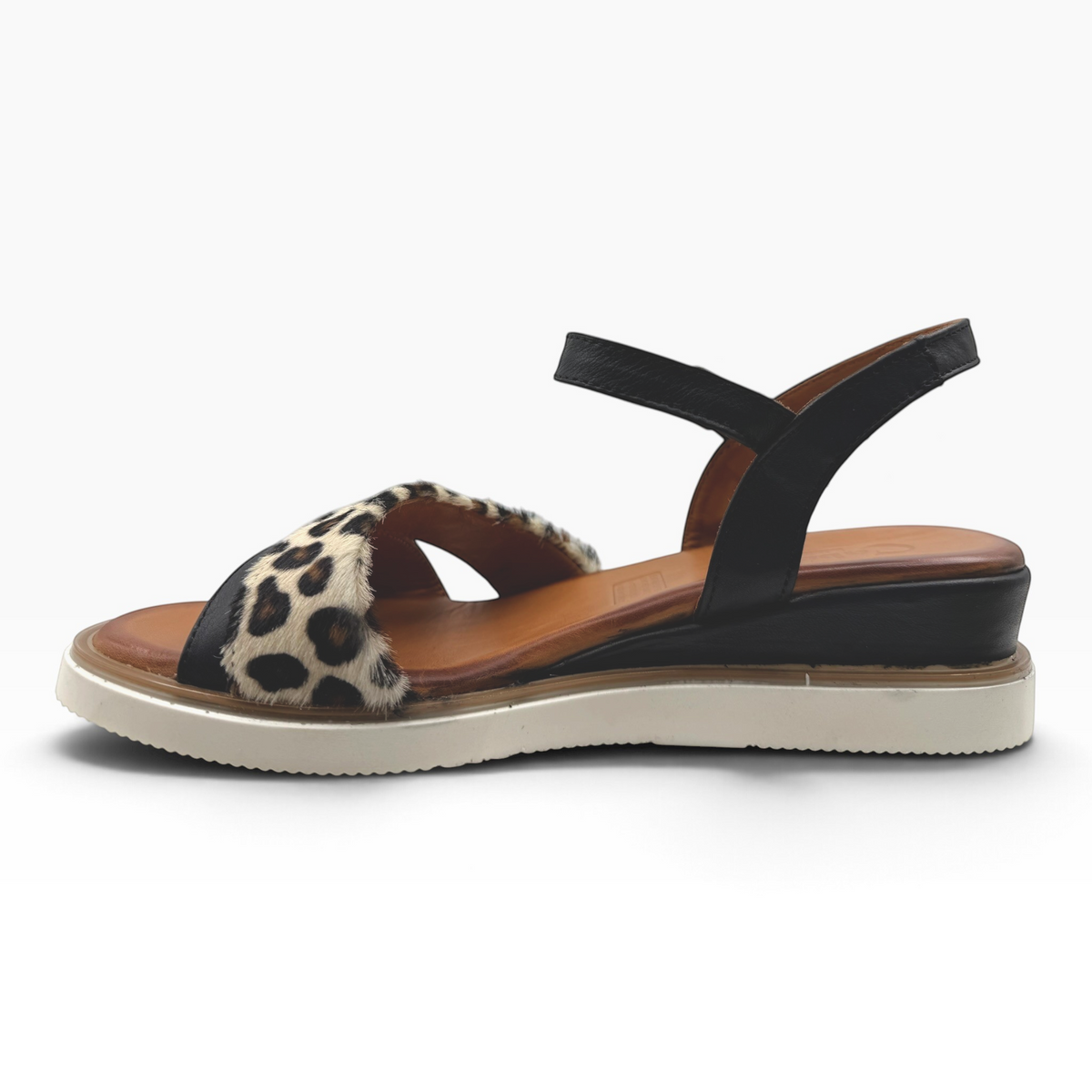 The Shoe Shop Eclipse sandal featuring leopard-print leather crossover straps, a black ankle strap, and a wedge heel.