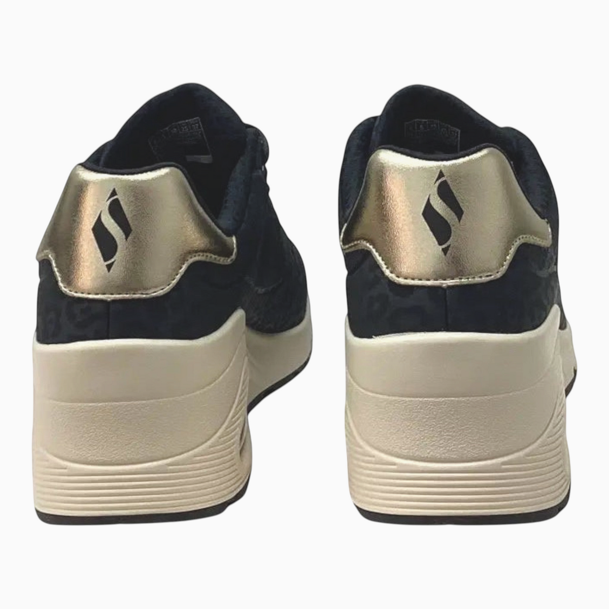 The Shoe Shop Skechers Uno Wedge Safari Daze sneakers featuring black leopard print and metallic gold heel detail.