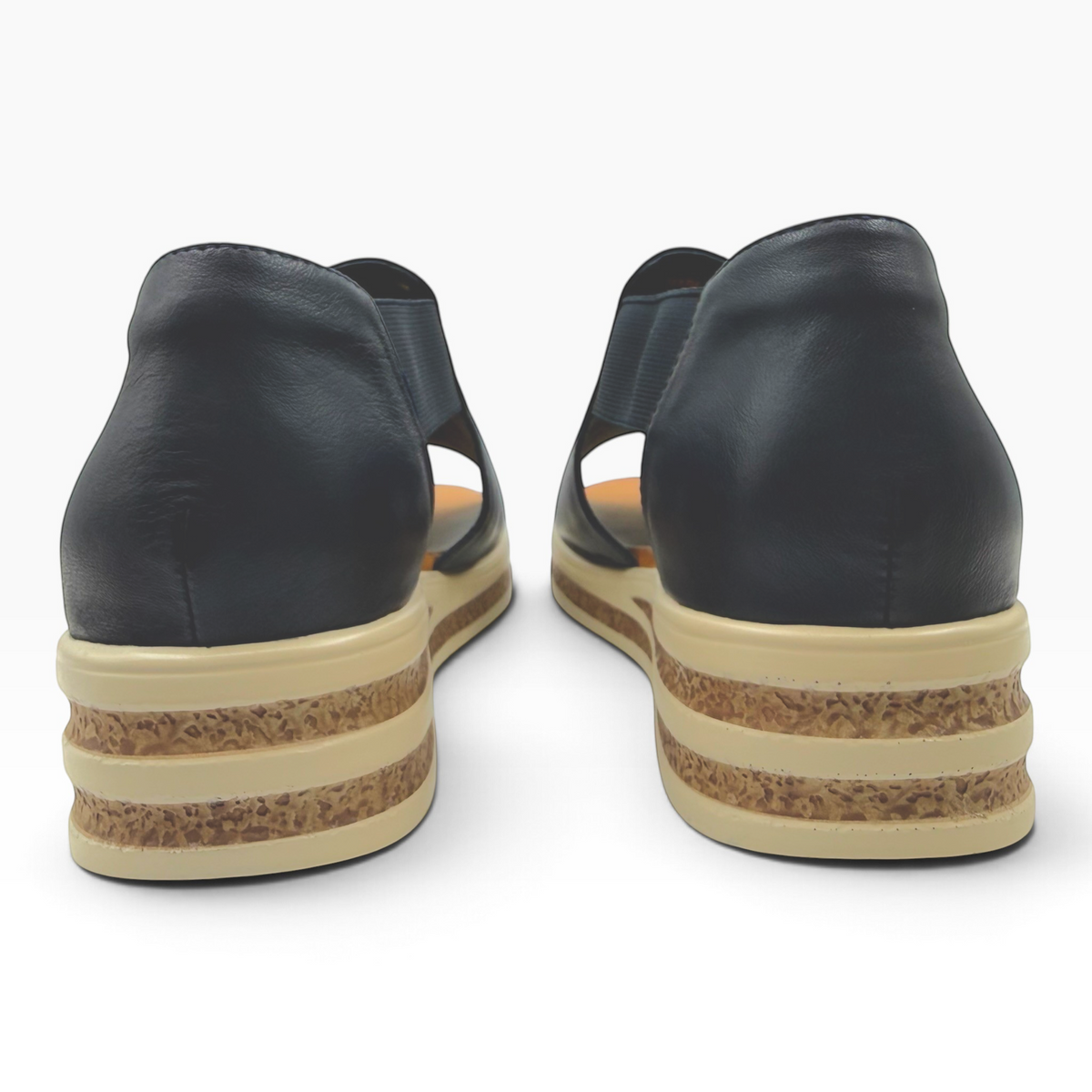 The Shoe Shop Machu black leather sandals with a beige textured platform sole viewed from the back