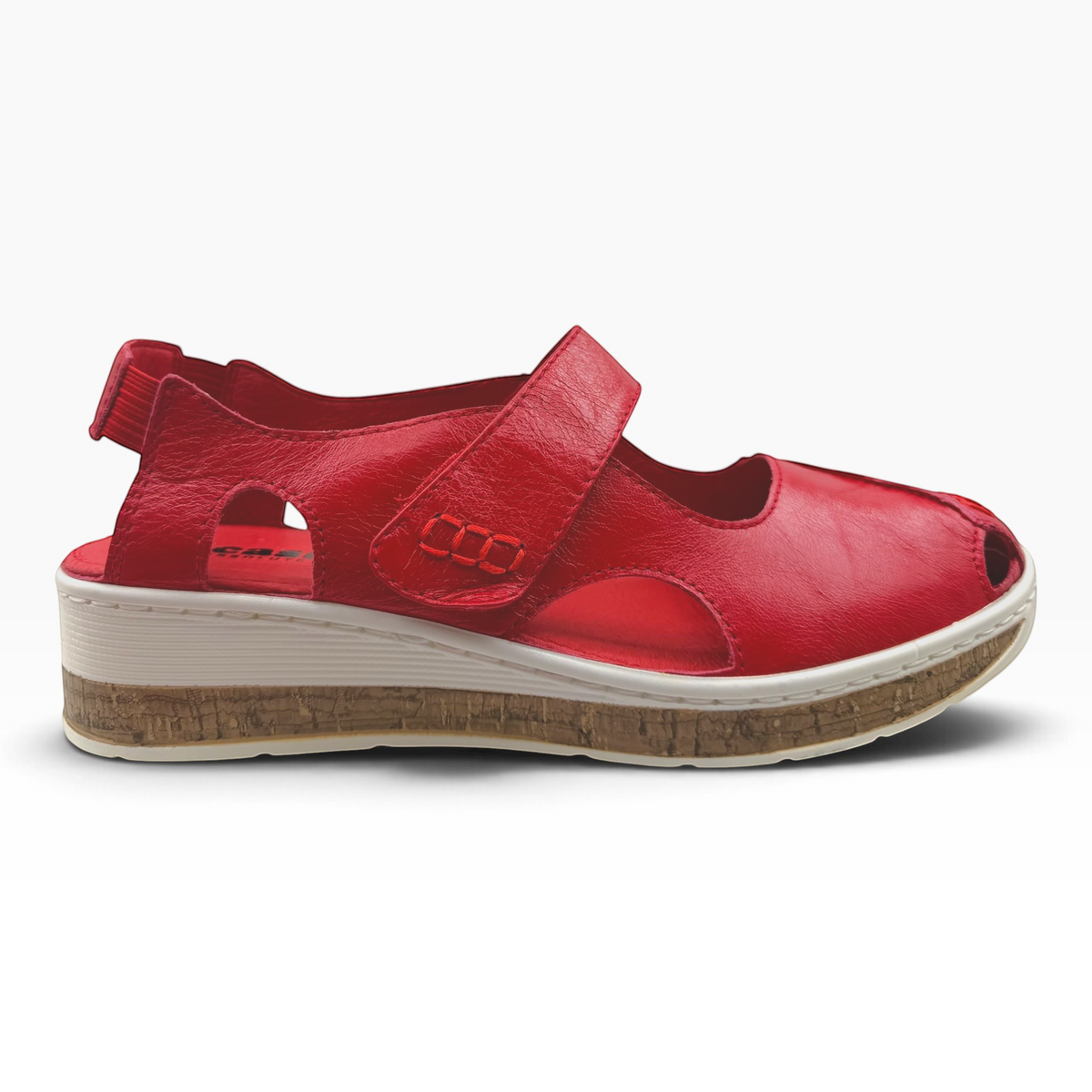 The Shoe Shop Maizy red leather peep-toe sandal with adjustable strap, side cut-outs, and cork-effect wedge sole.