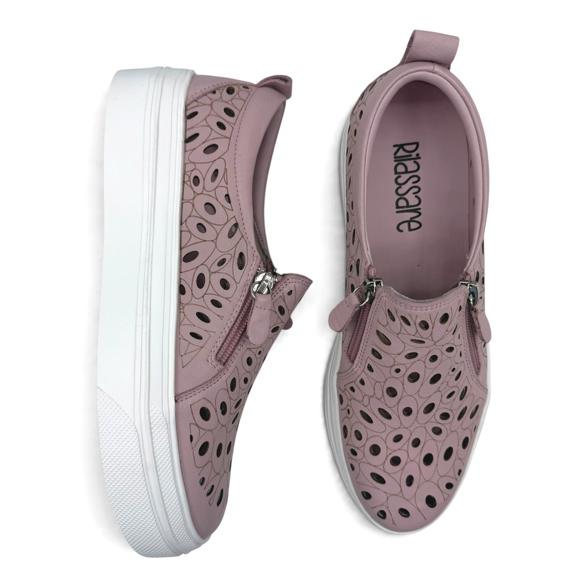 The Shoe Shop Triffic mauve leather sneakers with laser-cut floral patterns, side zips, and white platform soles.