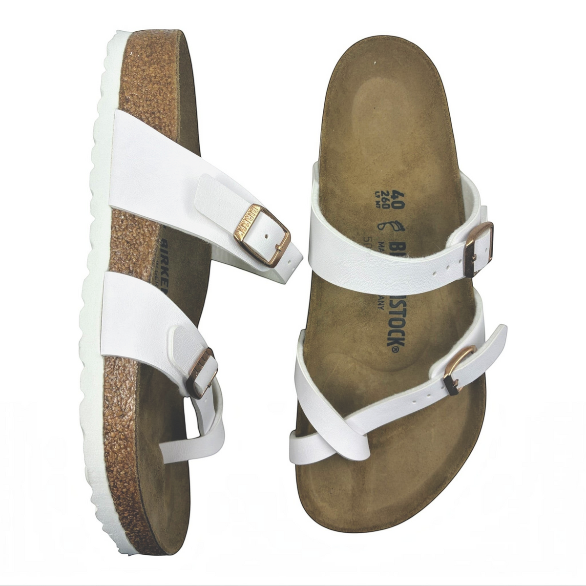 The Shoe Shop Mayari Birko-Flor white sandals with criss-cross toe loop, cork-latex footbed, and adjustable buckles.
