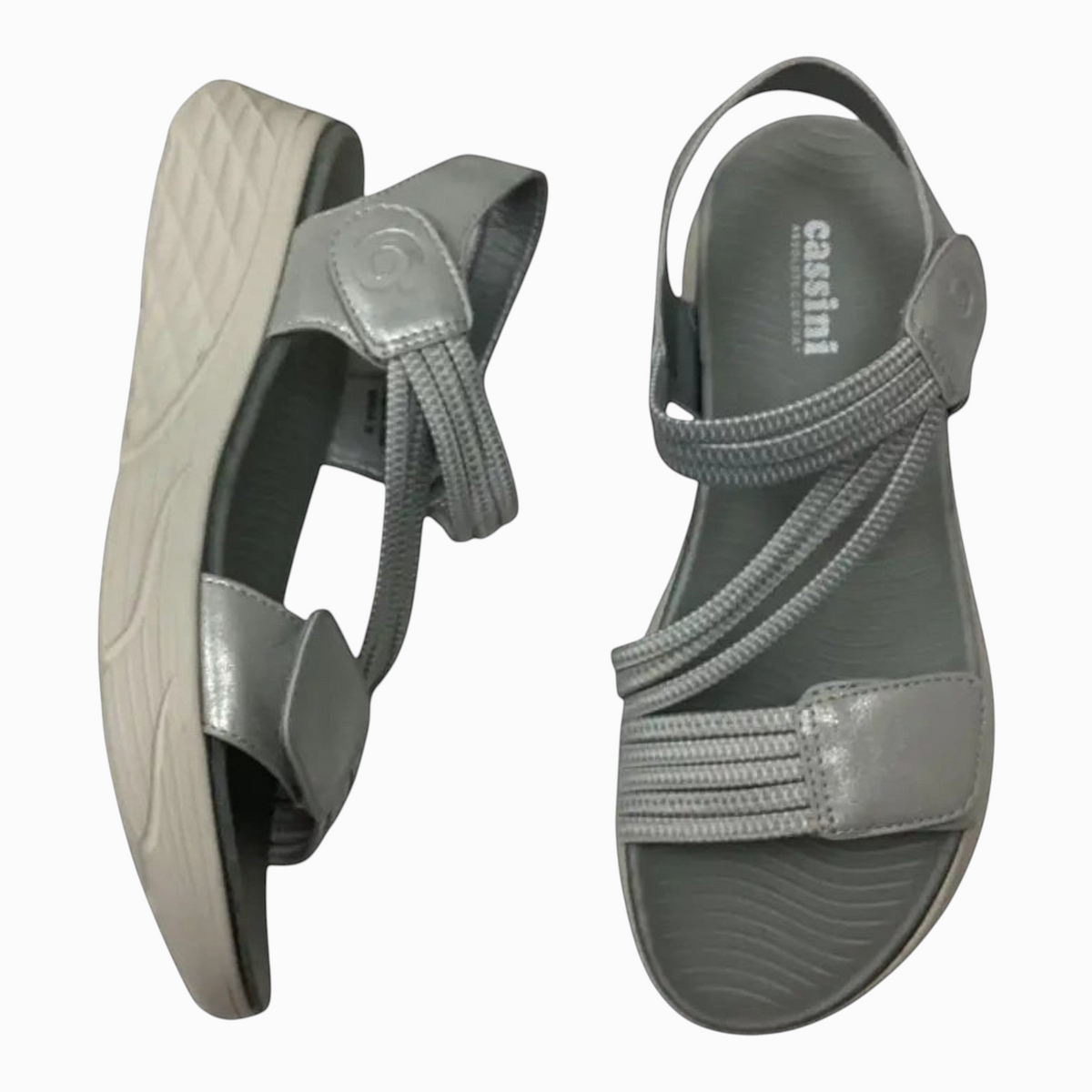 The Shoe Shop Menova silver synthetic sandals with elastic straps, Velcro fasteners, and a lightweight EVA sole.