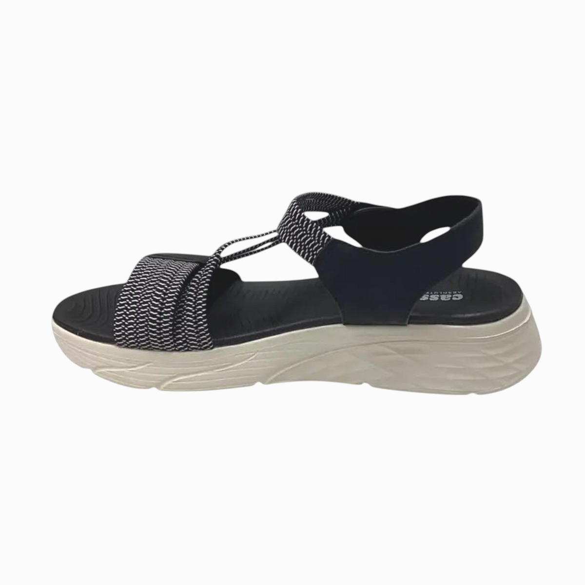 The Shoe Shop Menova black and white synthetic sandal with elastic straps, velcro fasteners, and molded EVA sole.