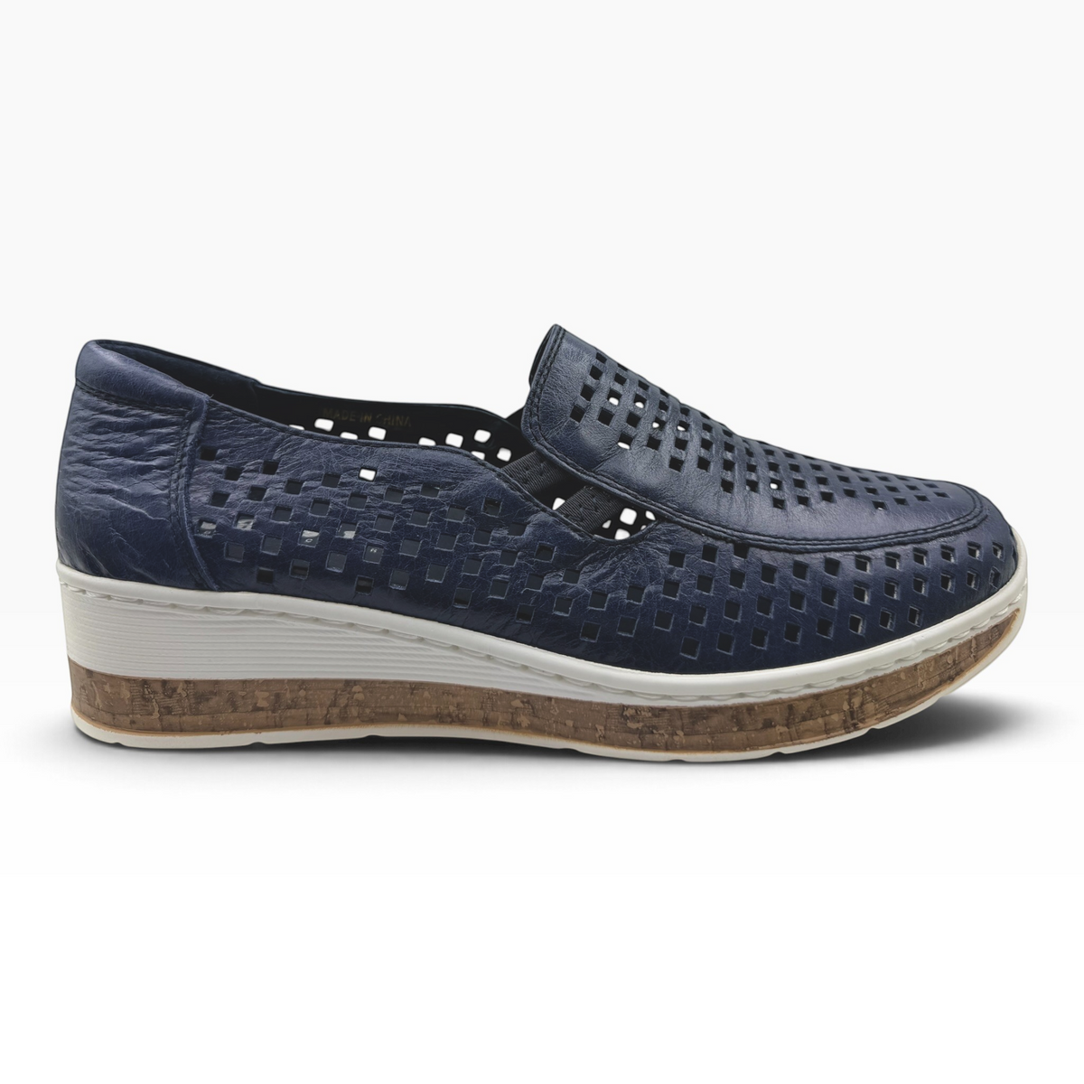 The Shoe Shop Monkey casual navy blue leather slip-on shoe with laser-cut details and a cork-effect wedge sole