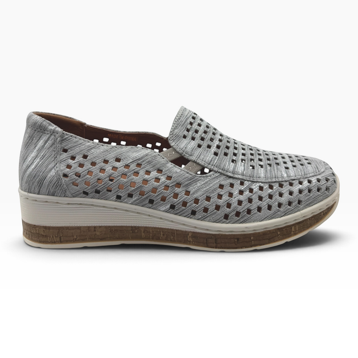 The Shoe Shop Monkey casual slip-on shoe in metallic silver with a laser-cut pattern and a cork-effect wedge sole.