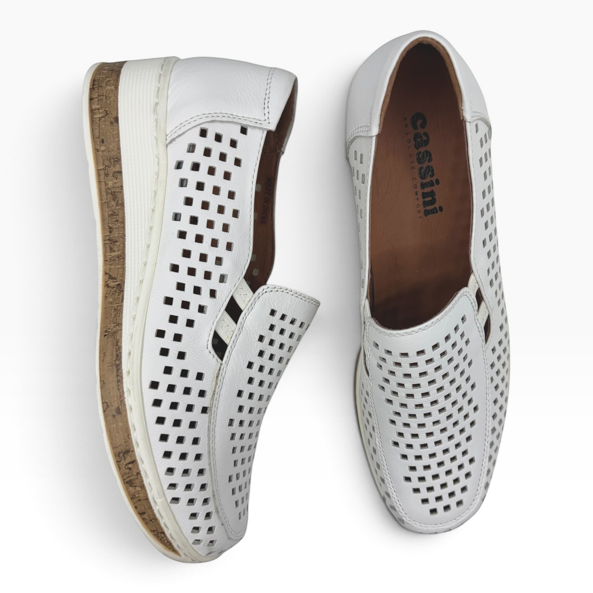 The Shoe Shop Monkey casual white leather slip-on shoes with a perforated design and cork-textured wedge sole