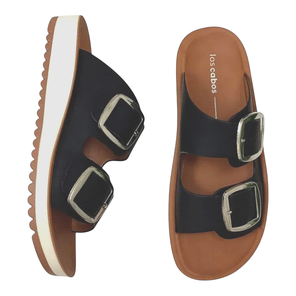 The Shoe Shop Naara black vegan leather double-strap slides with adjustable silver buckles and a low wedge sole.