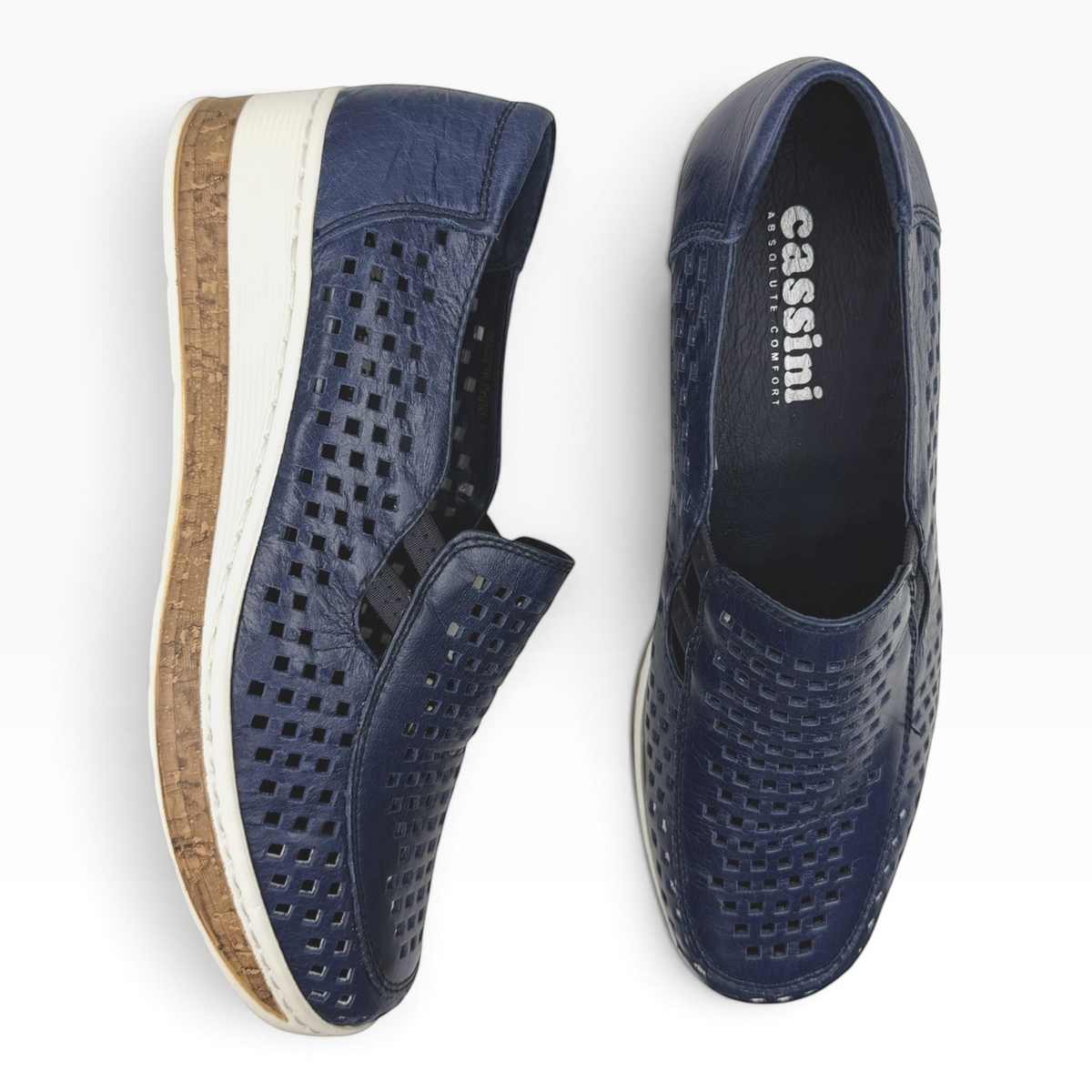 The Shoe Shop Monkey navy blue leather slip-on shoes with laser-cut perforated details and a cork-effect wedge sole.