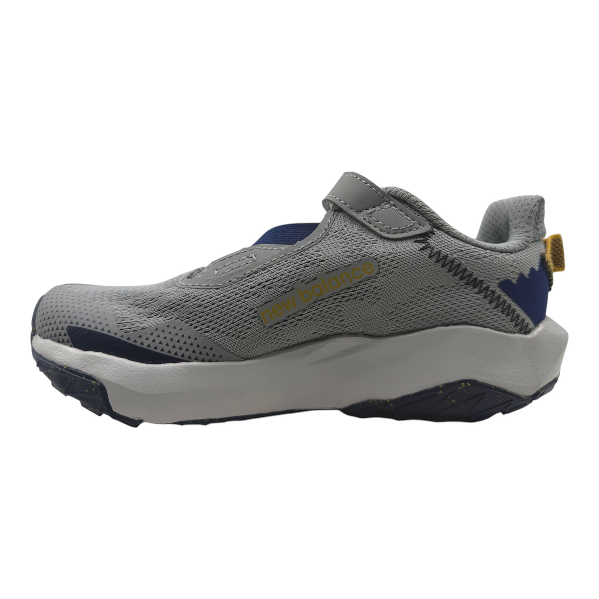 The Shoe Shop New Balance Nitrel v6 kids sneaker in grey with blue accents, featuring a cushioned midsole and strap.