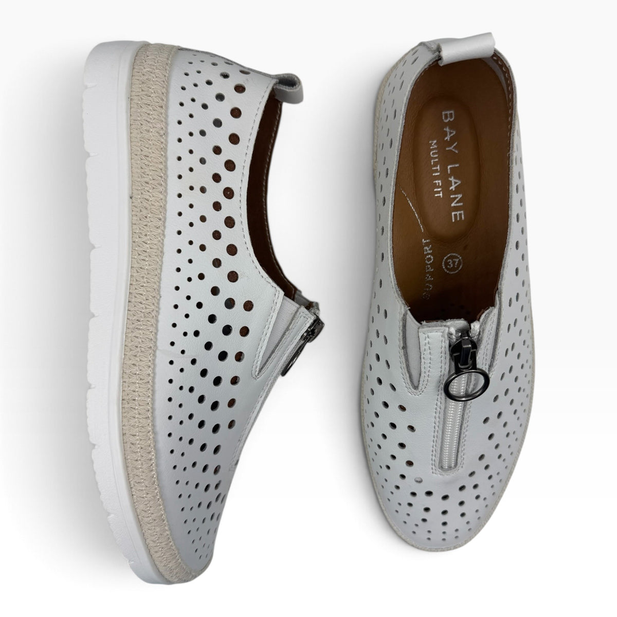 The Shoe Shop New Mercury white perforated leather slip-on sneakers with front zip closure and espadrille trim.