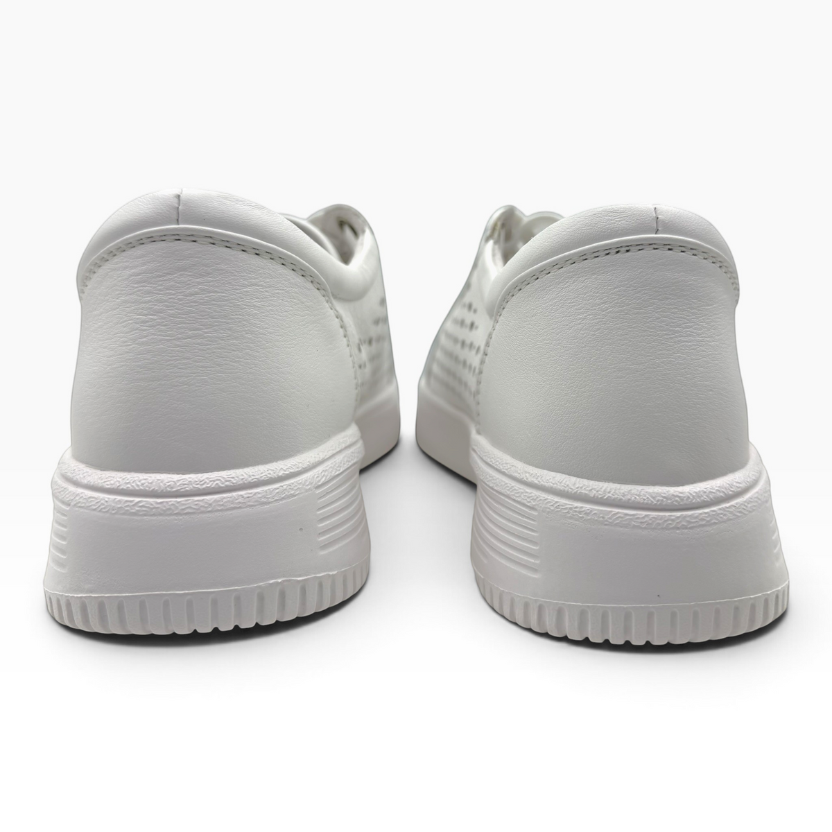 The Shoe Shop Noble white leather sneakers showing the back view with a lightweight platform sole and textured heel.